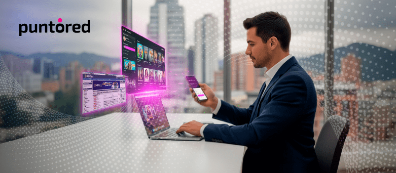 Ejecutivo gestionando pagos digitales en entretenimiento desde laptop y móvil.